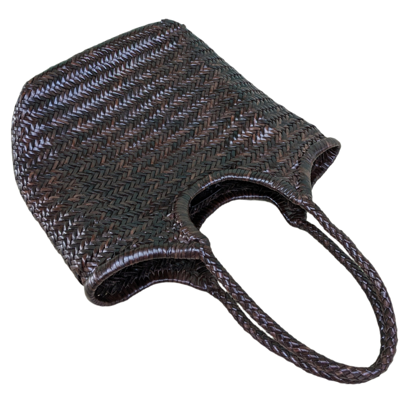 Brown woven bag on a light wooden floor with a blue wall in the background