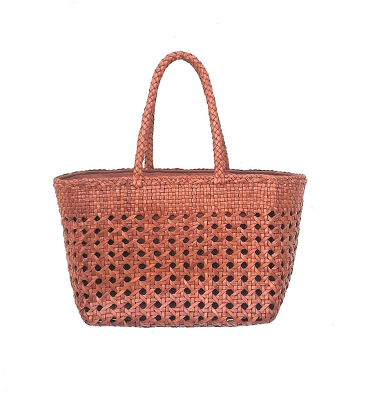 Woven handbag with a perforated design on a white background