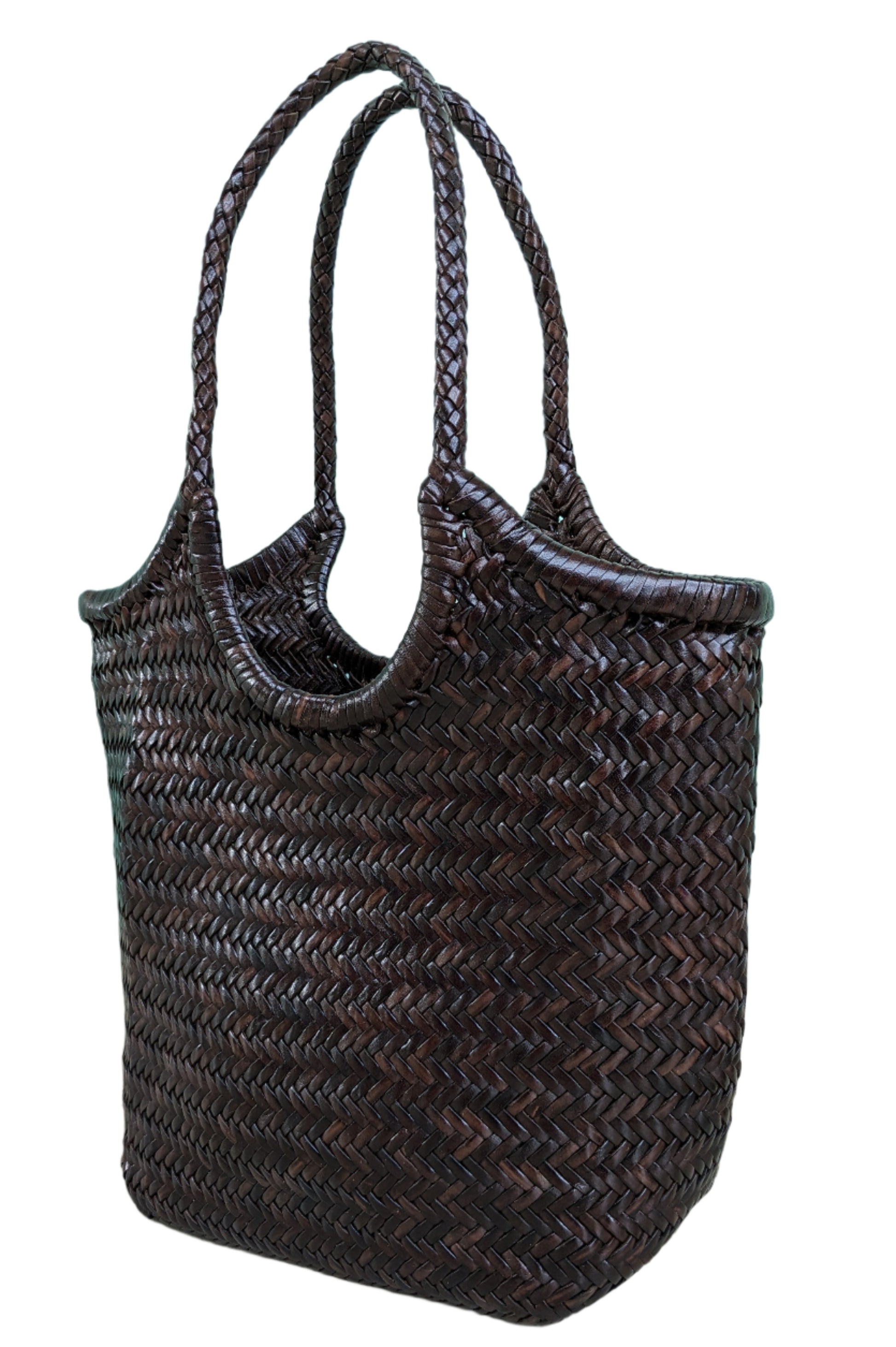 Woven brown bag on a light blue wall and wooden floor background