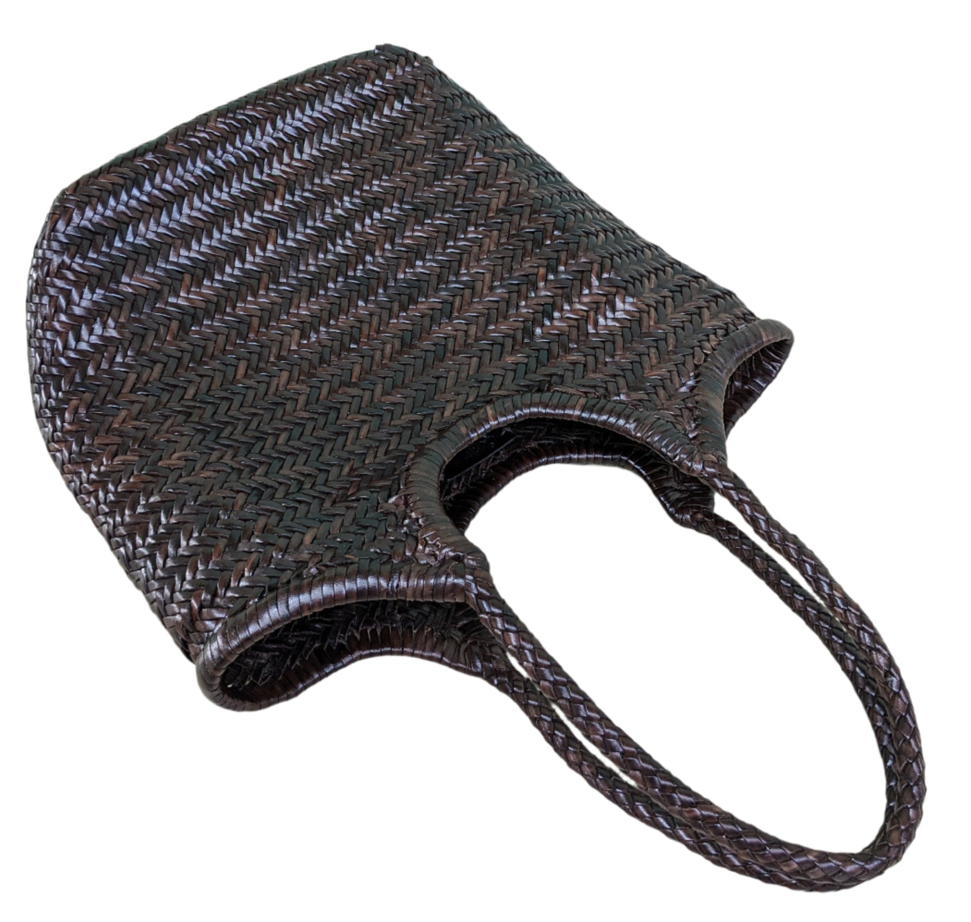 Brown woven bag on a light wooden floor with a blue wall in the background